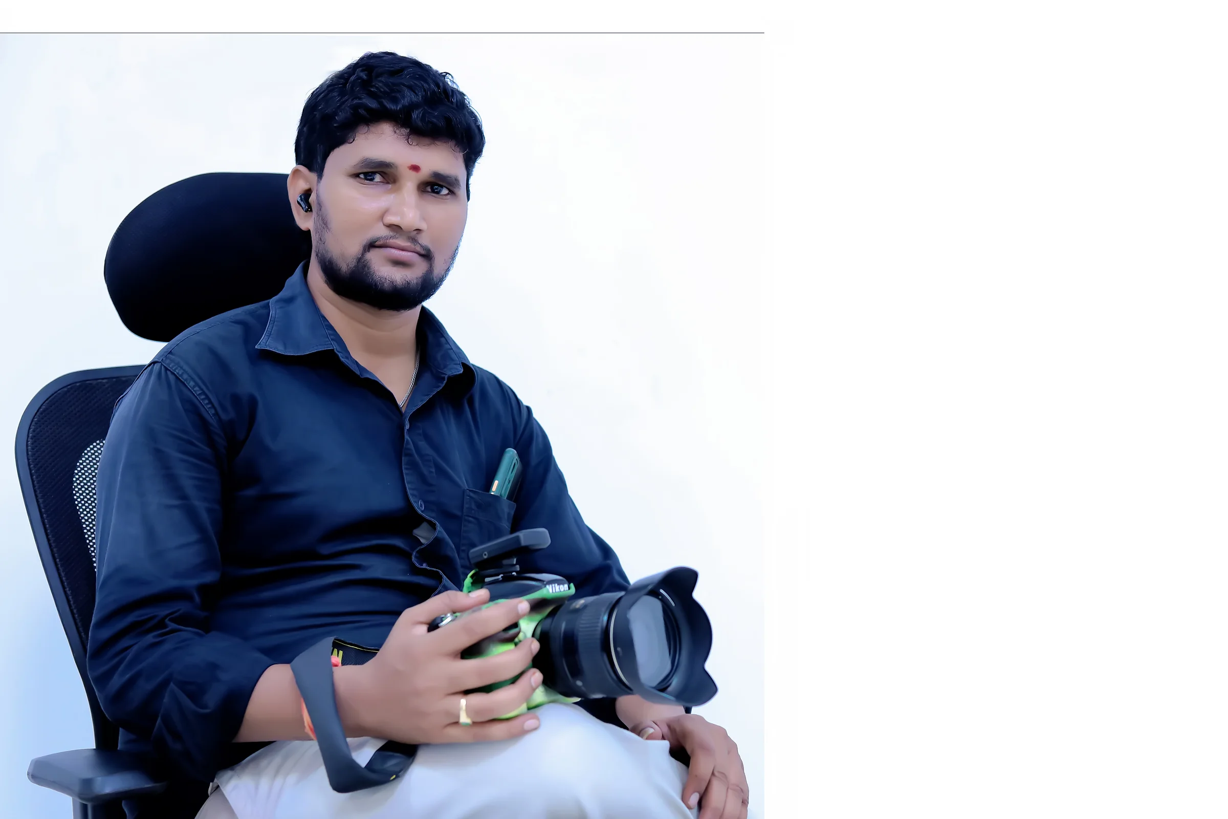 BABU STUDIO photographer holding his camera